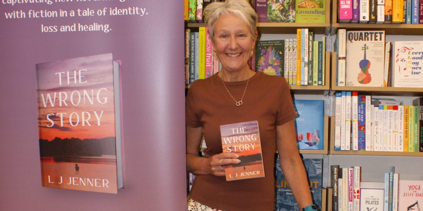 L. J. Jenner holding paperback copy of The Wrong Story